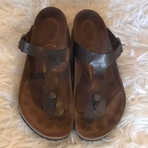 Birkenstock brown thong sandals.